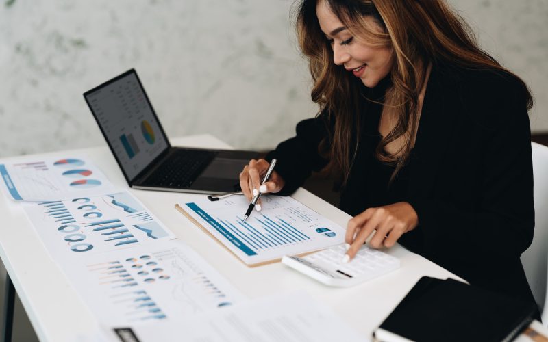 usiness-analyzing-investment-charts-with-calculator-laptop-accounting-and-technology-in-office.jpg